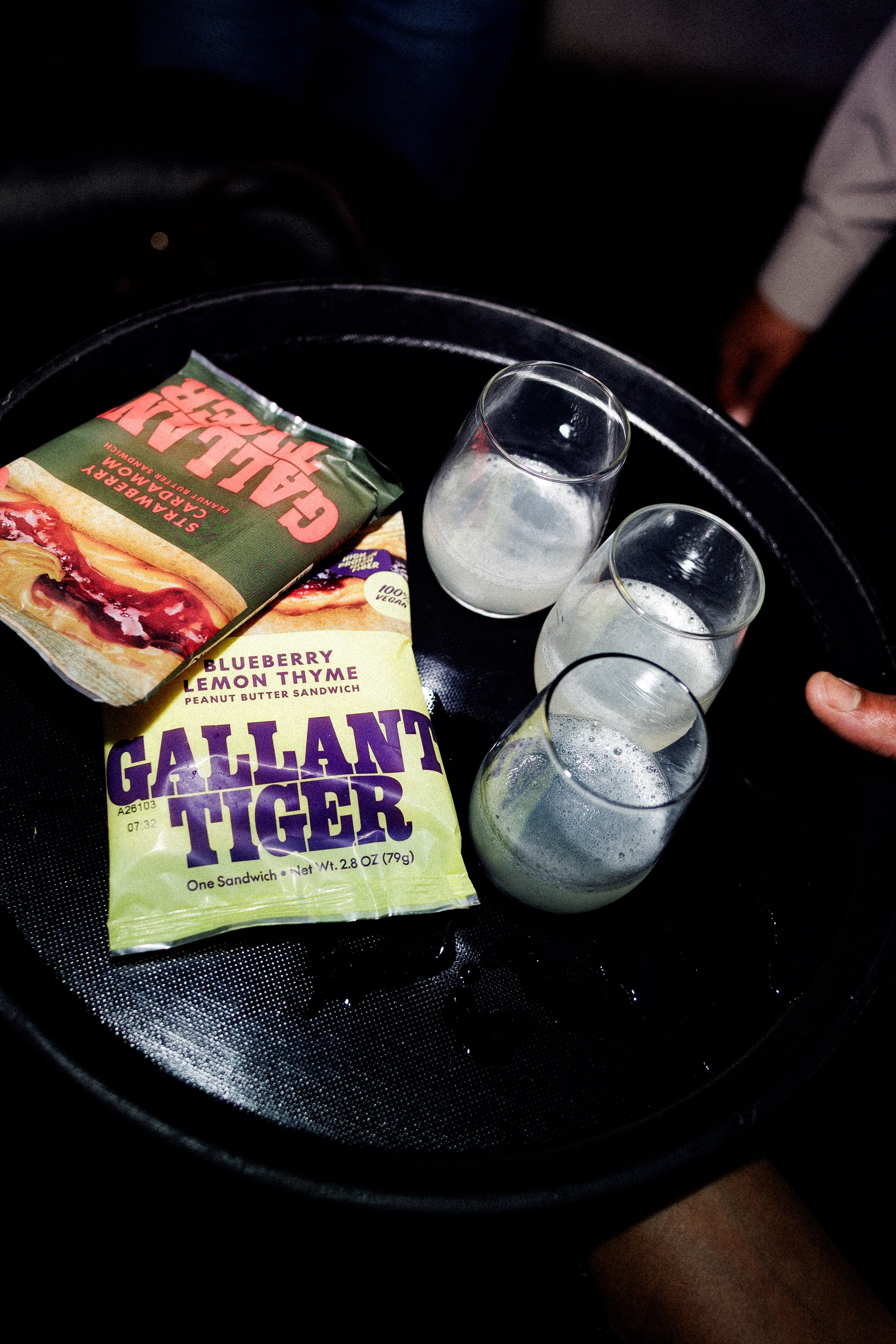Gallant Tiger sandwiches served with milk shots on a bar tray